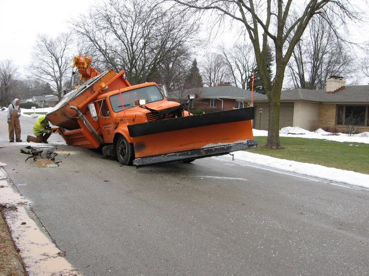 Local public works employees transform a plow truck into a pot hole, Rockford, IL, 2011.
